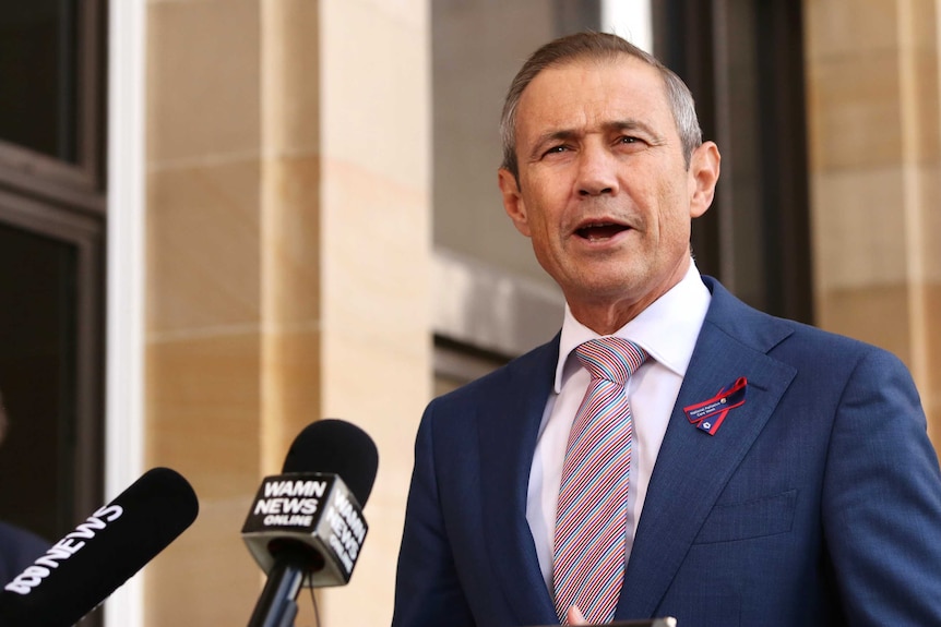 WA Health Minister Roger Cook addresses media outside parliament.