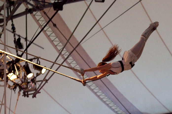 Adie Delaney swings through the air on a trapeze.