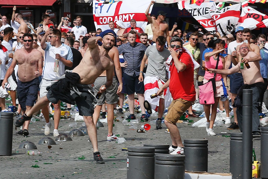 England supporters throw projectiles at the old port of Marseille before the game.
