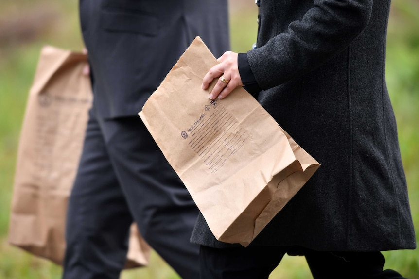 Police with evidence bag in William Tyrrell search