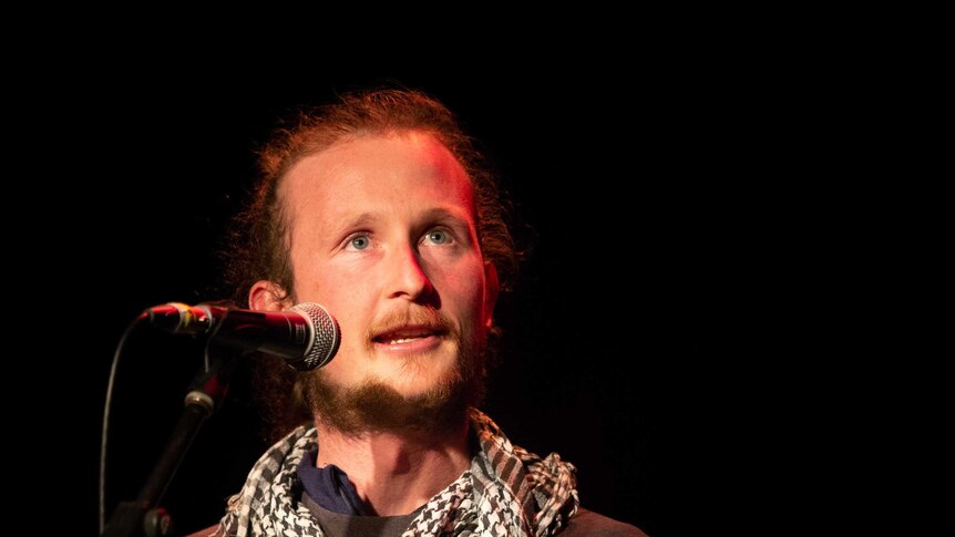 A man tells his story on stage at The Moth storytelling grandslam in Sydney
