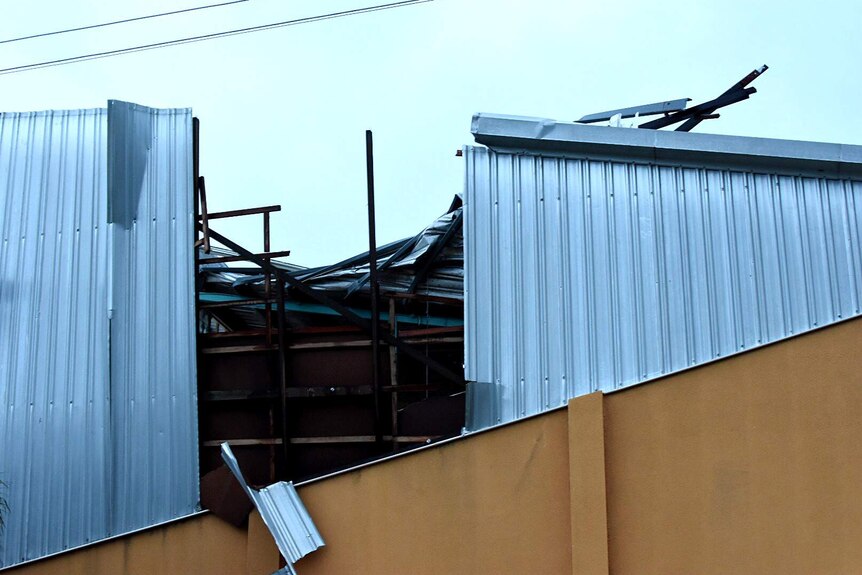Sheets of tin are seen ripped off a roof in Bowen