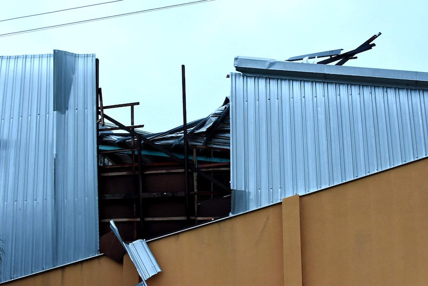 Sheets of tin are seen ripped off a roof in Bowen