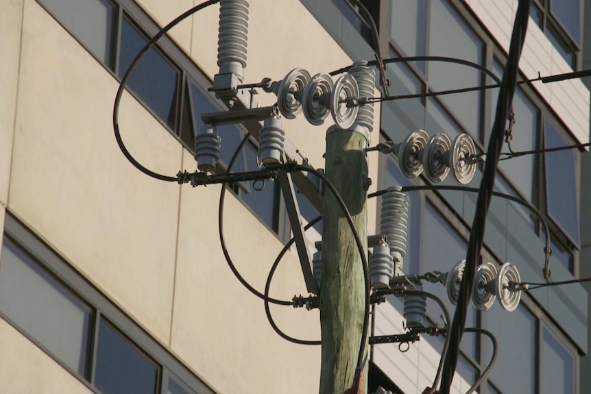 Close up of insulators on power lines outside an apartment block