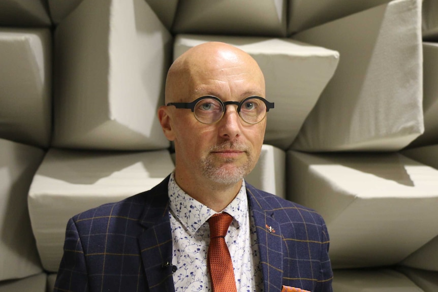 Professor David McAlpine stands inside the anechoic chamber at Macquarie University