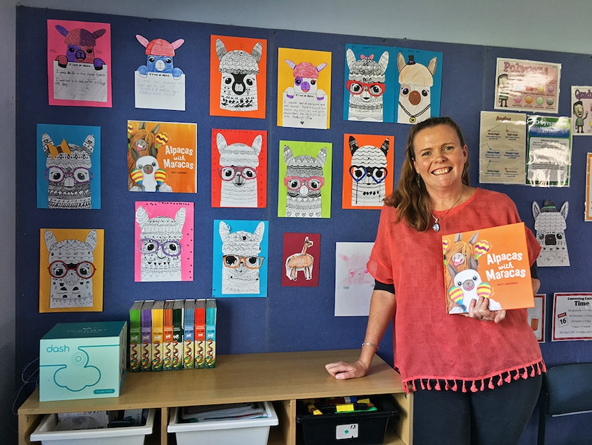 Kerrie Moore holding Alpacas with Maracas book.