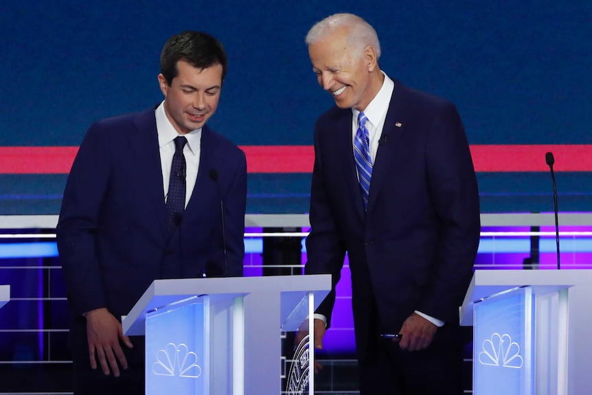 Two men laughing on a stage