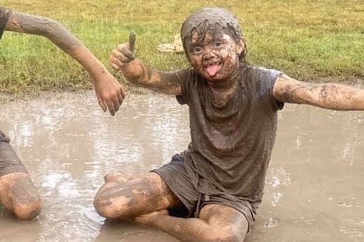 Kid in mud