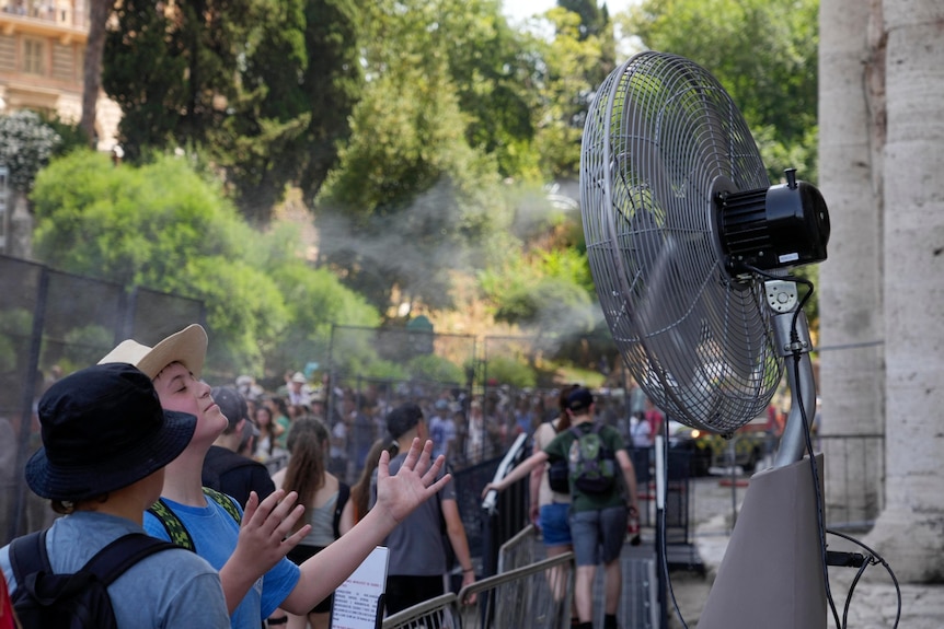 Tourists in front of a mist fan in Rome