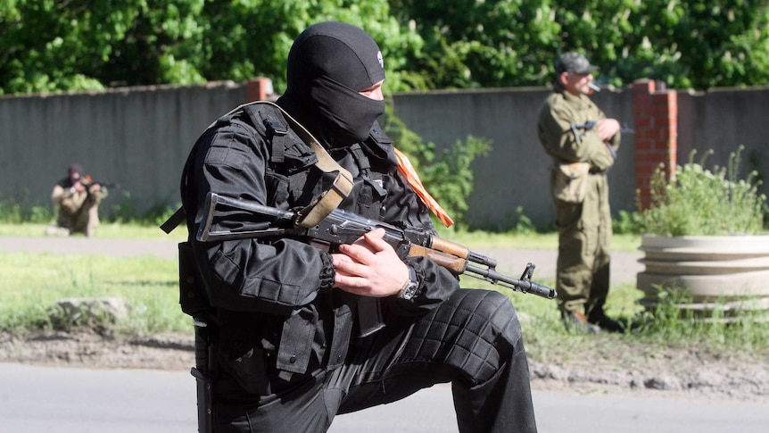 Armed pro-Russian militants take position in Donetsk.
