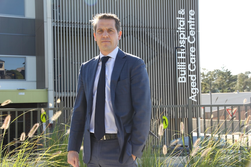 man standing in front of hospital