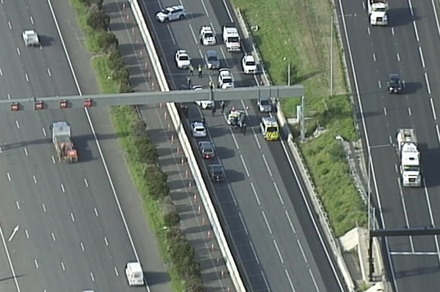 An aerial shot of several police cars and ambulances on the Monash Freeway.