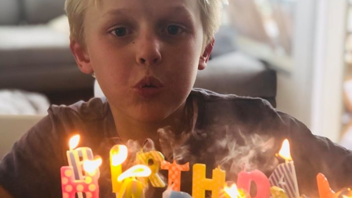 Max blowing out his candles on his 9th birthday