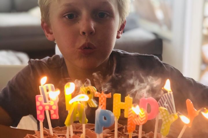 Max blowing out his candles on his 9th birthday