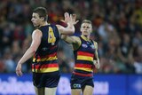 Adelaide's Josh Jenkins receives congratulations after kicking a goal against Collingwood.