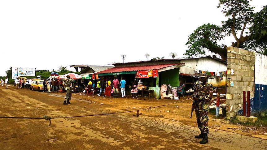 Soldiers guard border checkpoint in Liberia to help control spread of Ebola