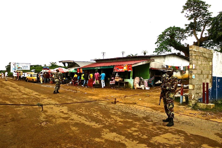 Soldiers guard border checkpoint in Liberia to help control spread of Ebola