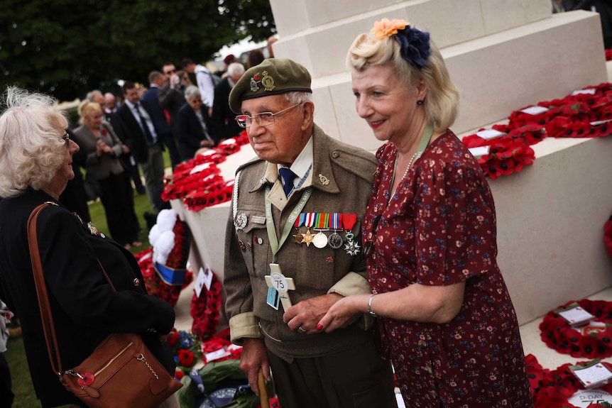 A WWII veteran poses for a photo at the end of the D-Day 75th anniversary ceremony.