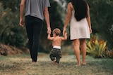 Man, woman and baby walk along holding hands in a story about the expectations and pressure to have sex after childbirth.