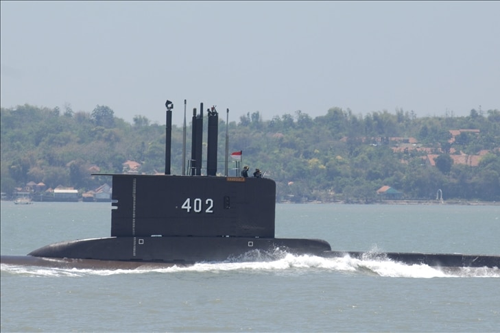 Pada hari yang mendung, Anda melihat kapal selam hitam melanggar garis air dengan antena periskop dan radionya.