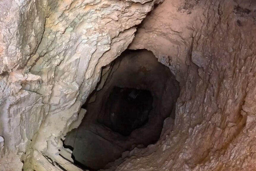 An aerial view of the inside of an abandoned mine shaft