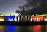Parliament House in Canberra is lit in the blue, white and red of the French Tricolore.