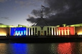 Parliament House in Canberra is lit in the blue, white and red of the French Tricolore.