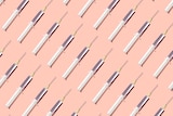 Repeated syringes on a pink background.