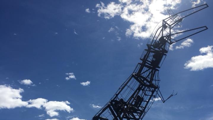 The metal skeleton of a burnt animatronic T Rex.