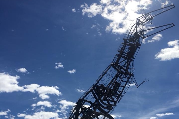 The metal skeleton of a burnt animatronic T Rex.