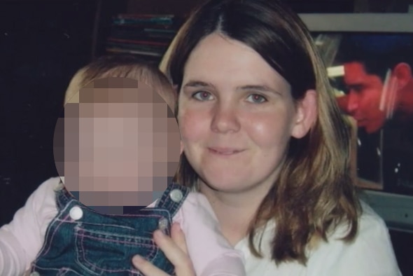 A woman with baby with face blurred out.