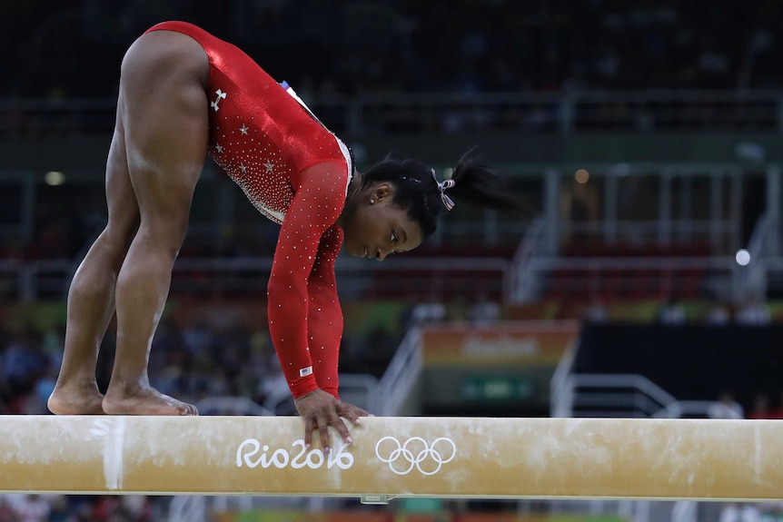 Simone Biles grabs the beam after a slip in the Rio gymnastics final
