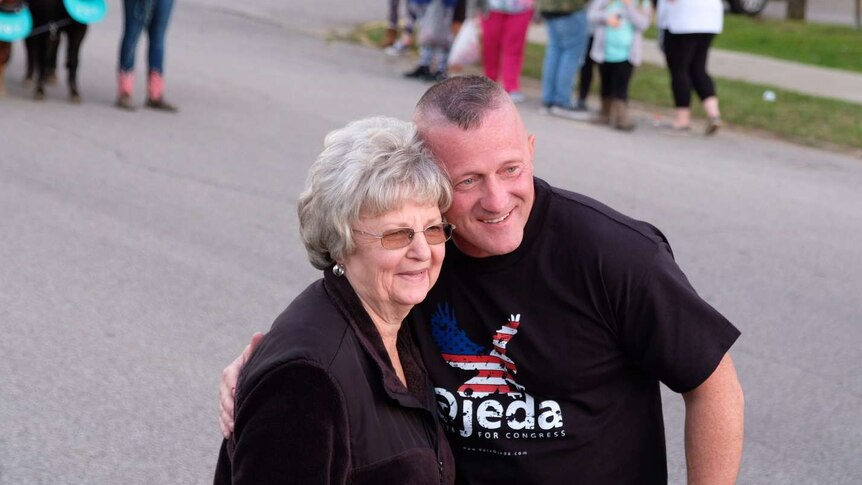 Political candidate Richard Ojeda stops to hug a voter and share a selfie in West Virginia