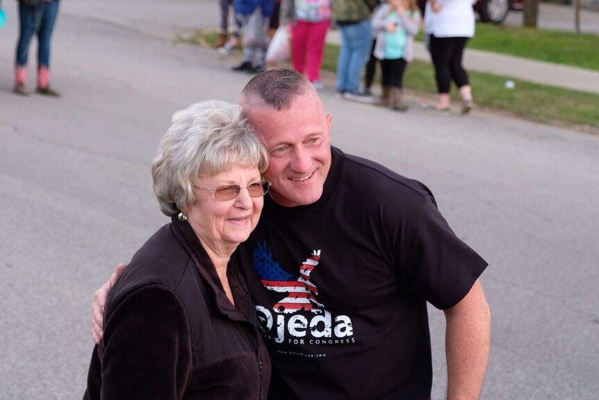 Political candidate Richard Ojeda stops to hug a voter and share a selfie in West Virginia.