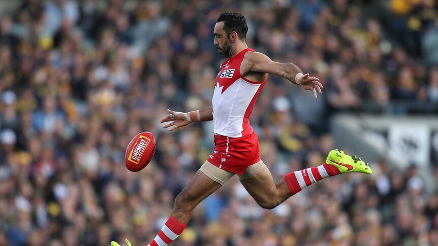 Colour photo of Adam Goodes of Swans kicking the ball during the round 17 AFL match against West Coast Eagles.