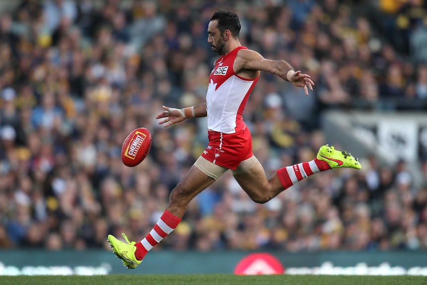 Colour photo of Adam Goodes of Swans kicking the ball during the round 17 AFL match against West Coast Eagles.