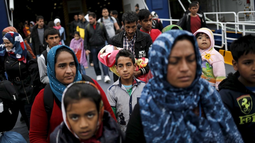 Asylum seekers from Iraq and Syria arrive at Piraeus by boat