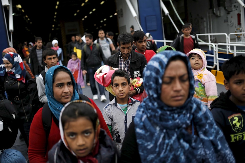 Asylum seekers from Iraq and Syria arrive at Piraeus by boat