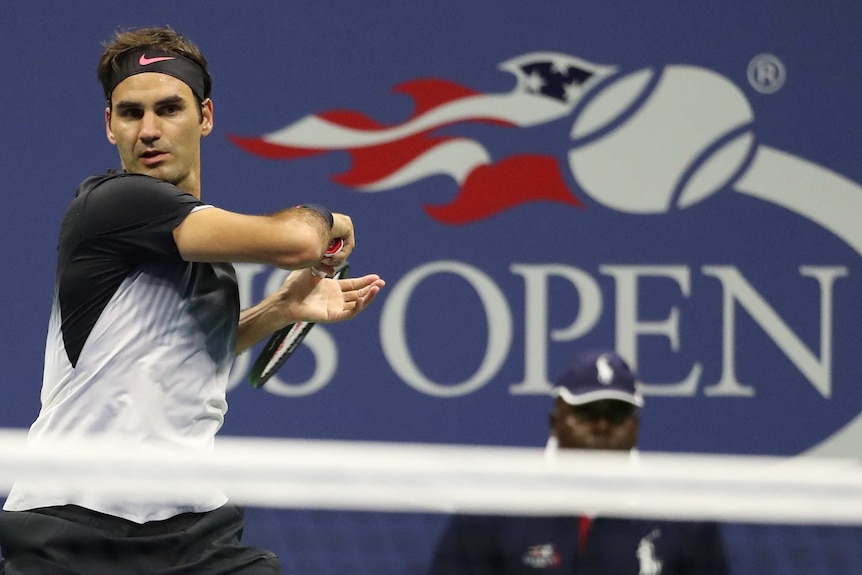 Roger Federer plays a forehand close to the net at the US Open.