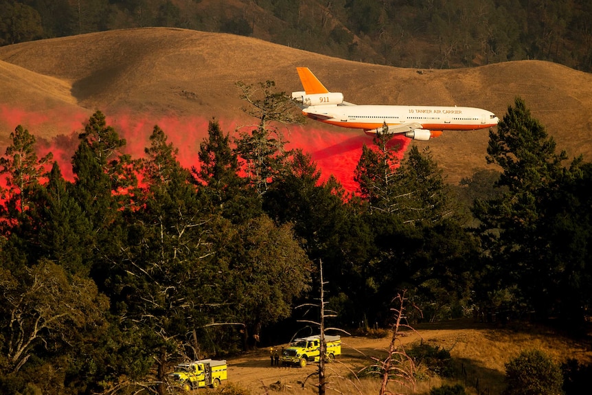 An air tanker drops retardant while battling the Kincade Fire.