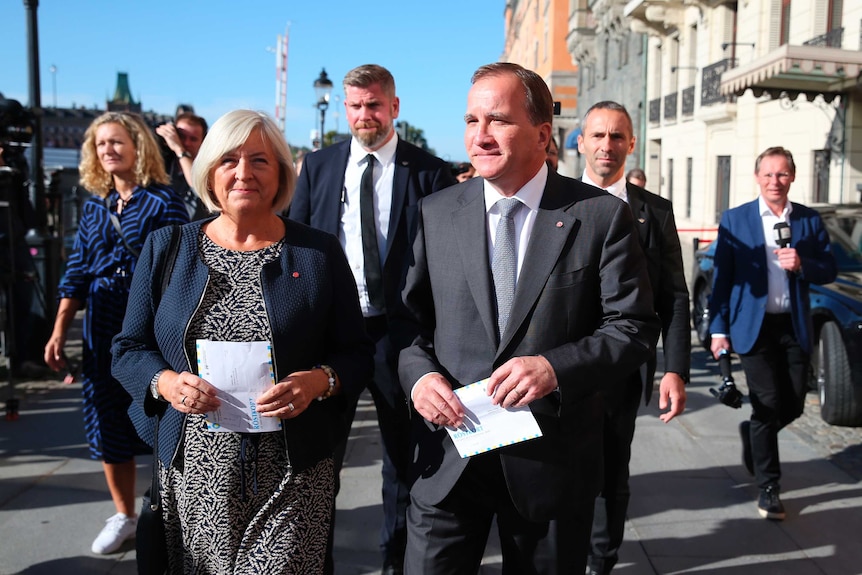 Stefan Lofven arrives with his wife Ulla to cast their votes