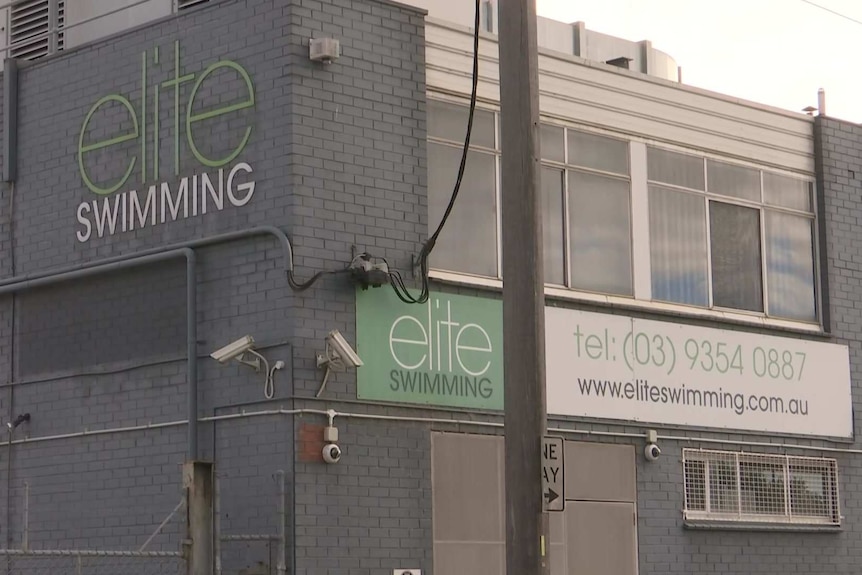 The exterior of a building with signage saying Elite Swimming