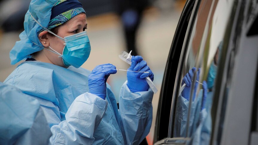 Nurses work at a drive-thru testing site for the coronavirus disease (COVID-19) in New York.