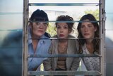 Katrina Milosevic, Sigrid Thornton and Brooke Satchwell look through a window towards the camera, looking concerned