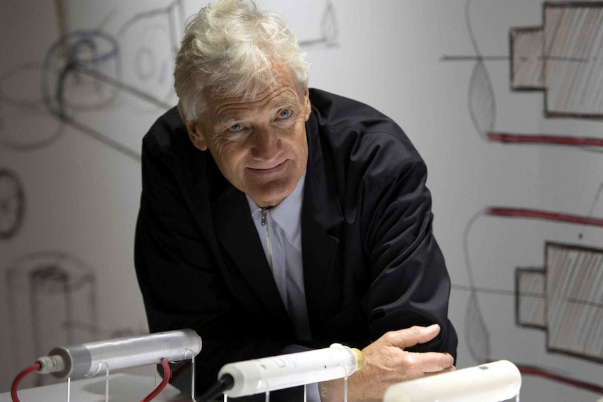 Sir James Dyson at a table