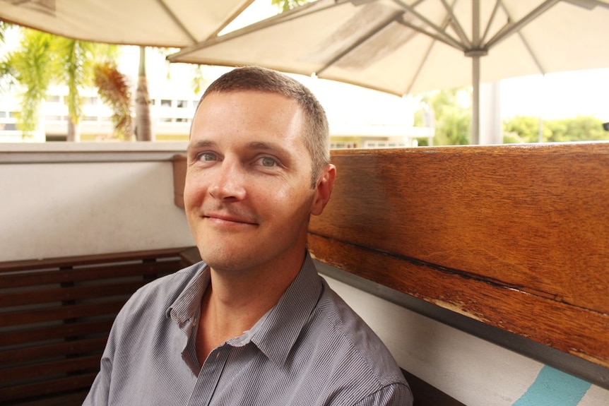 Matthew Willey sits in a cafe in Mackay
