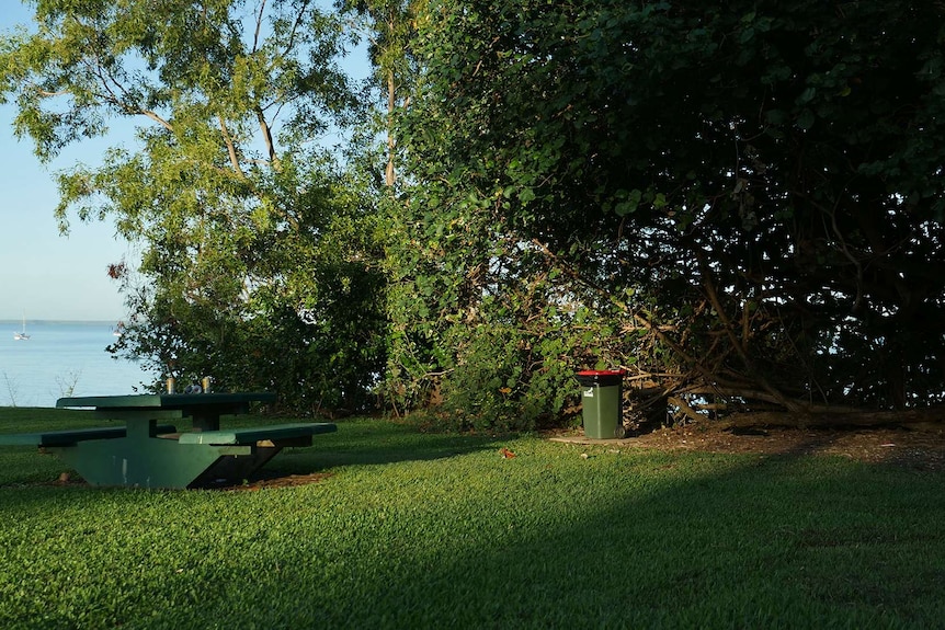 A photo of an abandoned picnic table in early morning light.