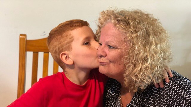 Xavier kisses his grandmother Sharon Wallace on the cheek.