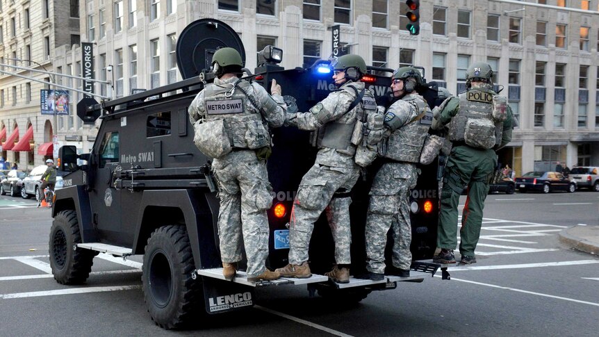 A Metro SWAT team drives through the Boston CBD after the explosions.