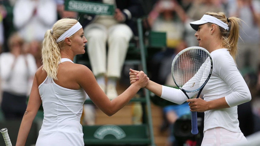 Russia's Maria Sharapova (R) shakes hands with France's Kristina Mladenovic at Wimbledon in 2013.